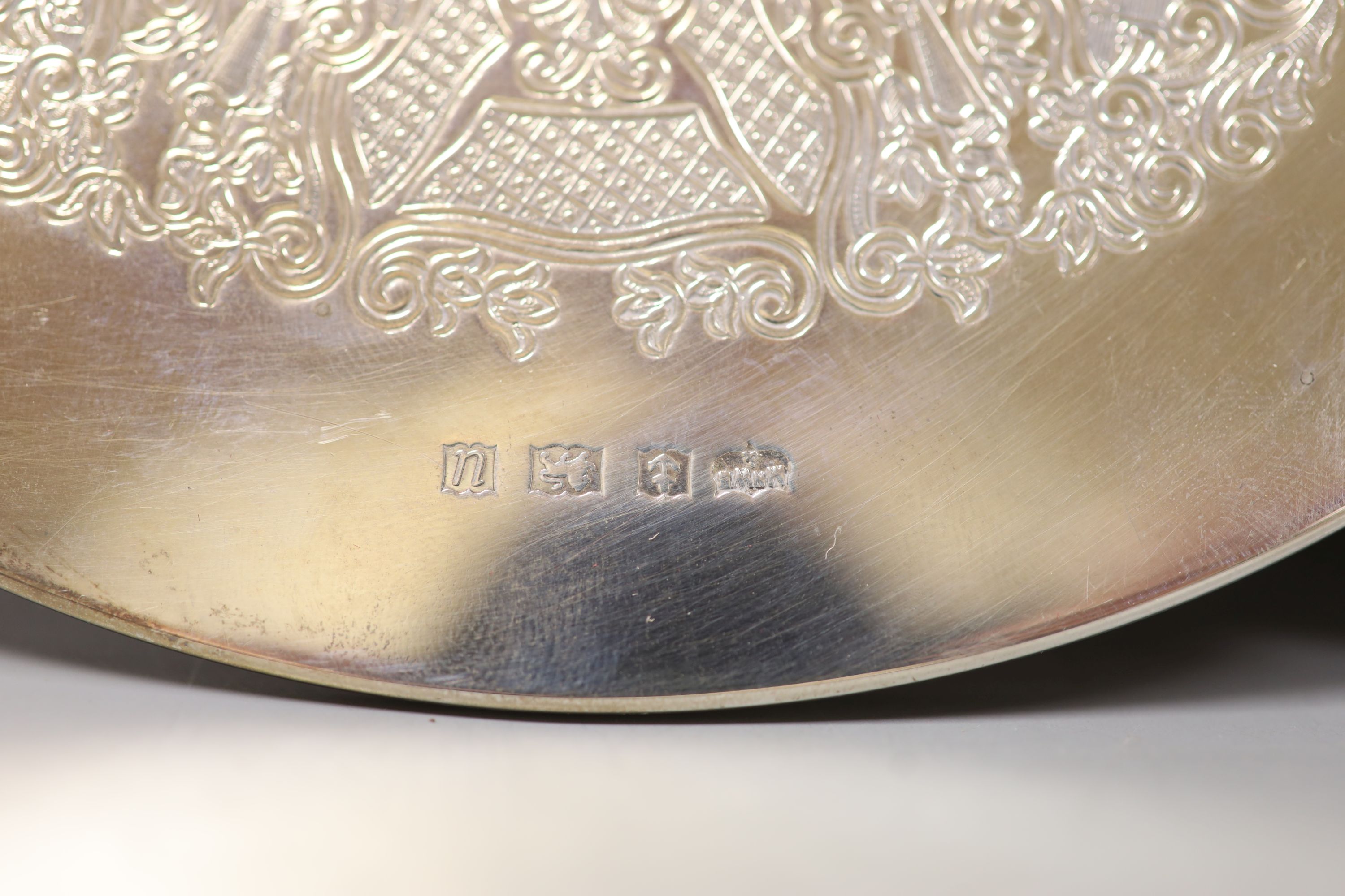 A set of six circular silver-mounted table mats